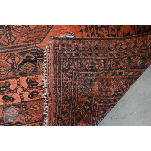 591 - An old Afghan rug with five medallions on pale red ground, 209 x 120 cm