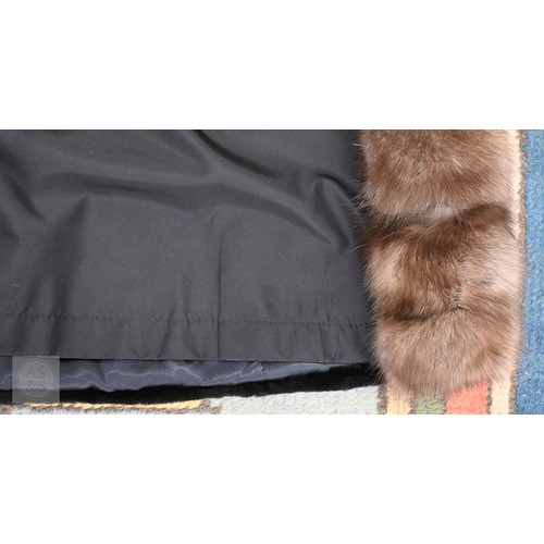 574 - A fur-timmed reversible long coat in black to/w a mid length fox fur jacket (2)