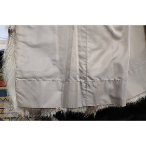 574 - A fur-timmed reversible long coat in black to/w a mid length fox fur jacket (2)