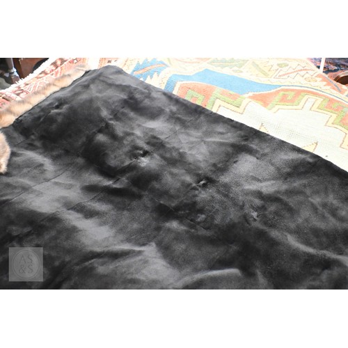 574 - A fur-timmed reversible long coat in black to/w a mid length fox fur jacket (2)