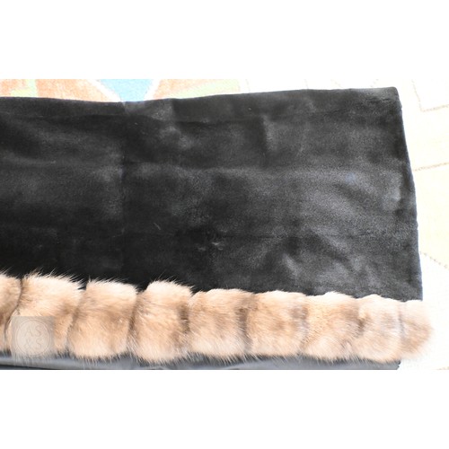 574 - A fur-timmed reversible long coat in black to/w a mid length fox fur jacket (2)