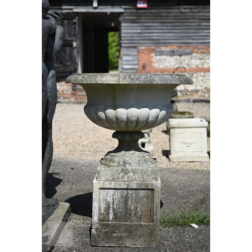 1 - A very large weathered cast stone garden urn planter in the Georgian style, 85 cm dia. raised on a s...