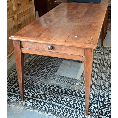 147 - A small French cherrywood dining table with cleated three-plank top and drawer to one end, raised on... 