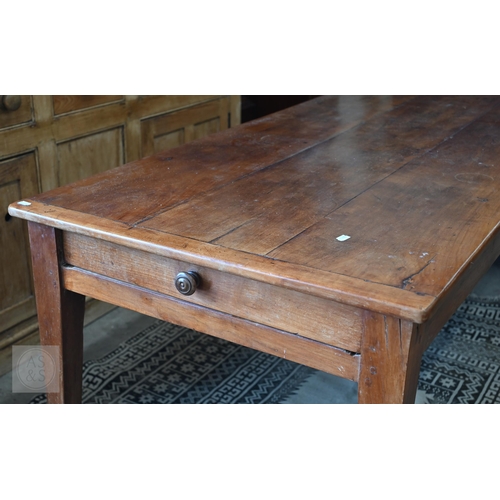 147 - A small French cherrywood dining table with cleated three-plank top and drawer to one end, raised on... 
