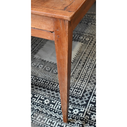 147 - A small French cherrywood dining table with cleated three-plank top and drawer to one end, raised on... 