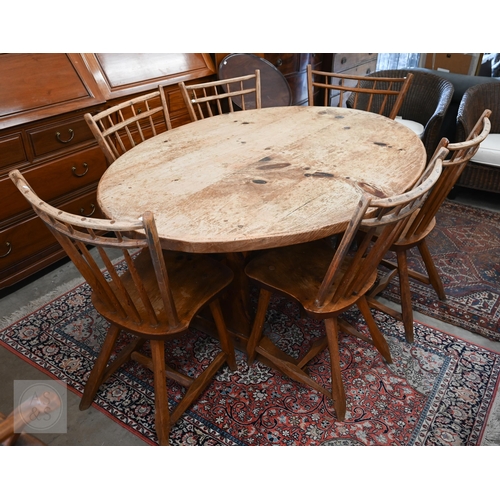 A Hunt Country Furniture set, the rustic pine oval dining table on trestle supports united by a pegged stretcher, 152 x 106 x 74 cm h to/w six provincial stick back chairs (five standard and one carver) and an oak and stained pine trolley