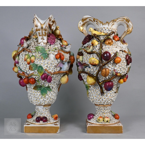 335 - A pair of 19th century porcelain floral-encrusted vases, applied with birds and fruit, on square bas... 