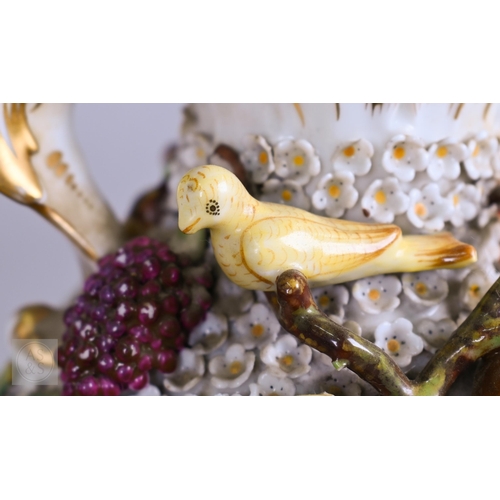 335 - A pair of 19th century porcelain floral-encrusted vases, applied with birds and fruit, on square bas... 