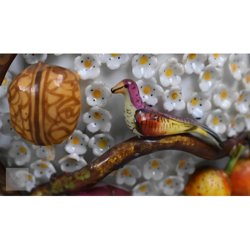 335 - A pair of 19th century porcelain floral-encrusted vases, applied with birds and fruit, on square bas... 