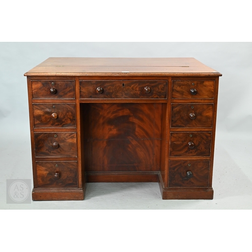 A George III mahogany architects/library desk, the adjustable easel top over an arrangement of nine drawers around a recessed kneehole, the sides each with four drawers, the verso with dummy moulded drawer fronts, raised on plinths, 101 cm w x 76 cm x 71 cm h