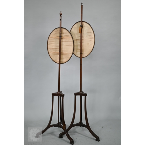 52 - A close matched pair of Sheraton design line inlaid tri-form base pole screens, the rise and fall gl... 