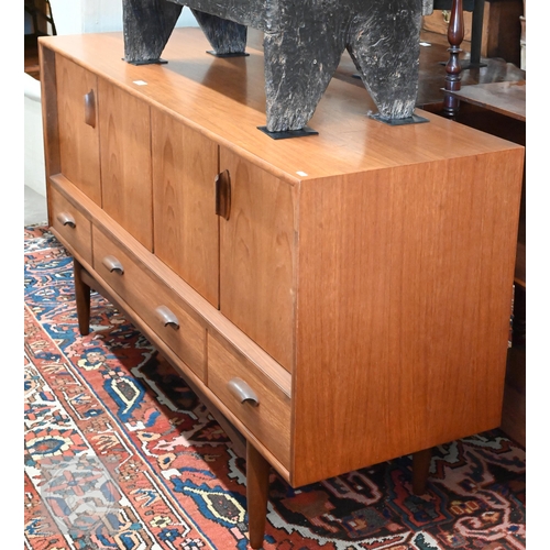 A Mid-Century G-Plan teak fresco sideboard circa 1960, folding cupboard doors over three drawers with moulded handles raised on turned supports, 145 x 45 x 82 cm high