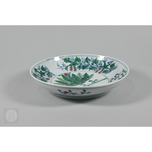 311 - A Chinese Doucai pomegranate dish, the stylised central tree surrounded by grape, peach and pomegran... 