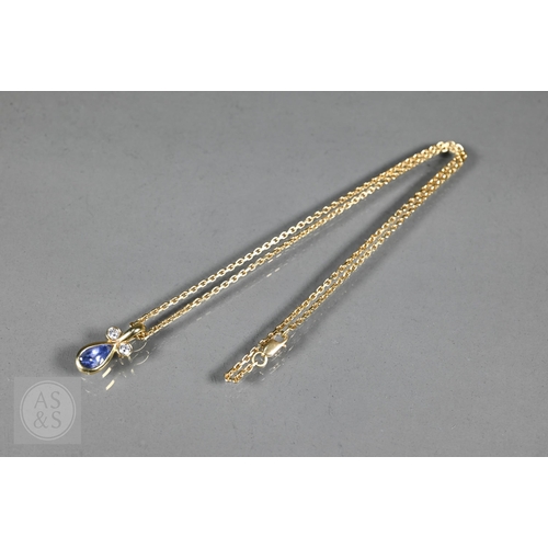 156 - An 18ct yellow gold pendant with tear-shaped blue sapphire and two collet-set diamonds above, on 18c... 