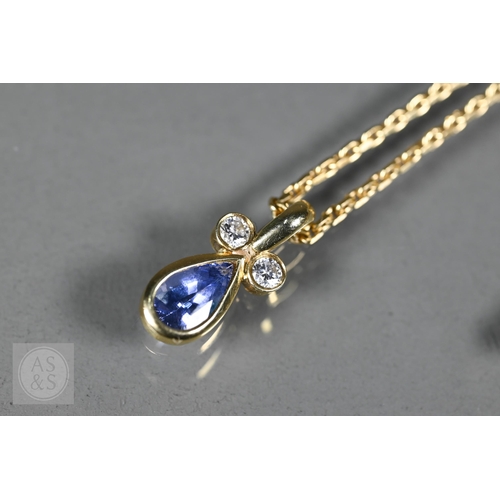 156 - An 18ct yellow gold pendant with tear-shaped blue sapphire and two collet-set diamonds above, on 18c... 