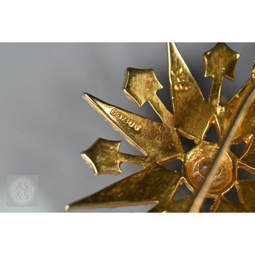 183 - A Victorian 9ct yellow gold starburst brooch set overall with seed pearls and a central old cut diam... 