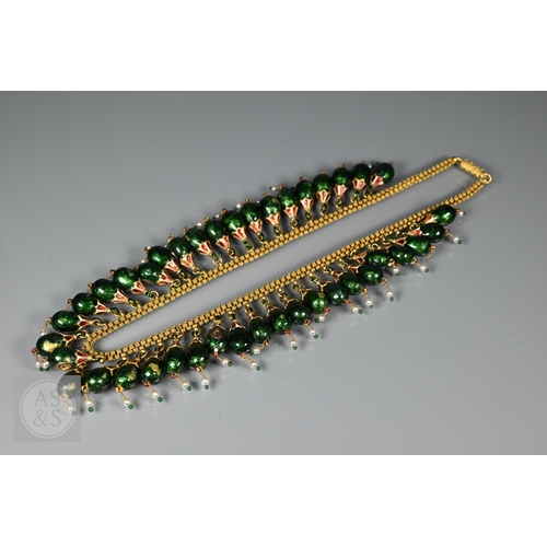 184 - An Indian fringe necklace of yellow metal chain with granulated links, suspending forty green, red a...