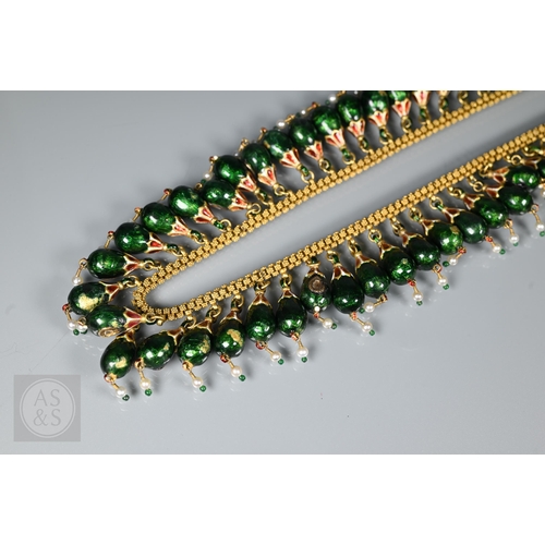 184 - An Indian fringe necklace of yellow metal chain with granulated links, suspending forty green, red a... 