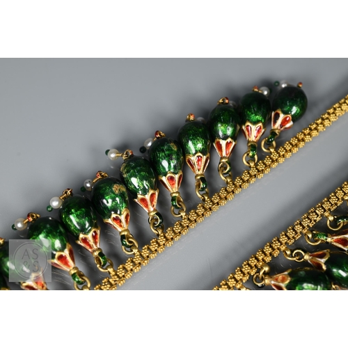 184 - An Indian fringe necklace of yellow metal chain with granulated links, suspending forty green, red a... 