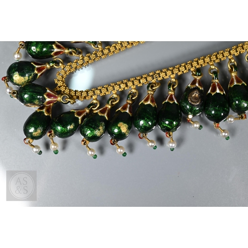 184 - An Indian fringe necklace of yellow metal chain with granulated links, suspending forty green, red a... 