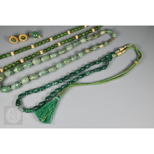 185 - A green jade bead necklace with yellow metal beads and clasp, stamped 14k; another green jade neckla... 