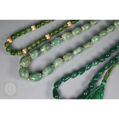 185 - A green jade bead necklace with yellow metal beads and clasp, stamped 14k; another green jade neckla... 