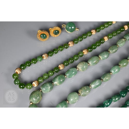 185 - A green jade bead necklace with yellow metal beads and clasp, stamped 14k; another green jade neckla... 