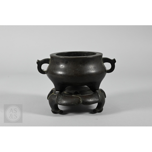 310 - A 17th/18th century Chinese bronze censer (incense burner) and original stand, the censer with compr... 