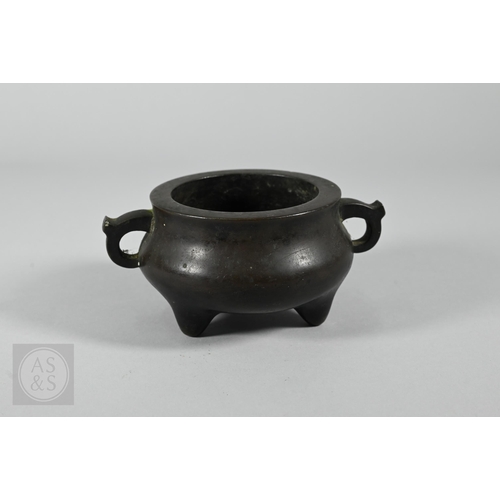 310 - A 17th/18th century Chinese bronze censer (incense burner) and original stand, the censer with compr... 