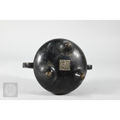 310 - A 17th/18th century Chinese bronze censer (incense burner) and original stand, the censer with compr... 