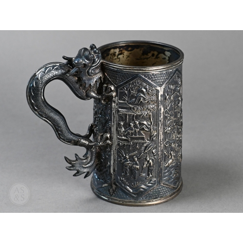 50 - An antique Chinese export silver tankard with finely-modelled dragon handle, the sides richly chased...