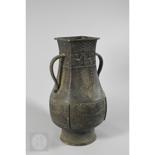 341 - A 19th century Chinese bronze twin handled vase in the form of an archaic ritual vessel, low relief ... 