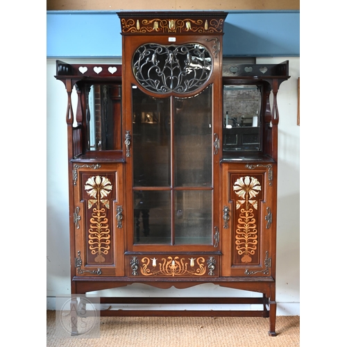 Shapland & Petter, Barnsatple (1854-1999), a fine Art Nouveau mother of pearl and boxwood inlaid satinwood display cabinet, the 'Lily' model circa 1900, centred by a glazed in cabinet door with scrolling metal overlaid panel of organic form, raised on square tapering legs united by a stretcher, 136 cm w x 35 cm x 191 cm h