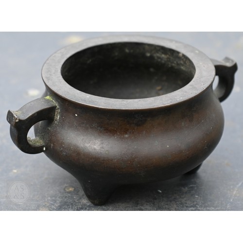 310 - A 17th/18th century Chinese bronze censer (incense burner) and original stand, the censer with compr... 