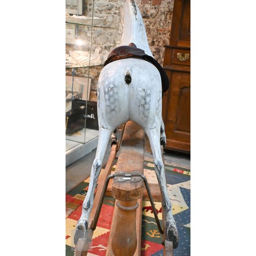588 - An antique dapple grey painted wooden rocking horse with leather saddle, probably by FH Ayres, raise... 
