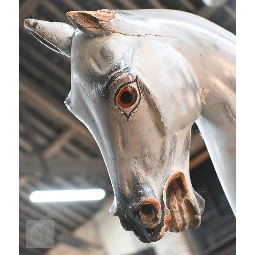 588 - An antique dapple grey painted wooden rocking horse with leather saddle, probably by FH Ayres, raise... 