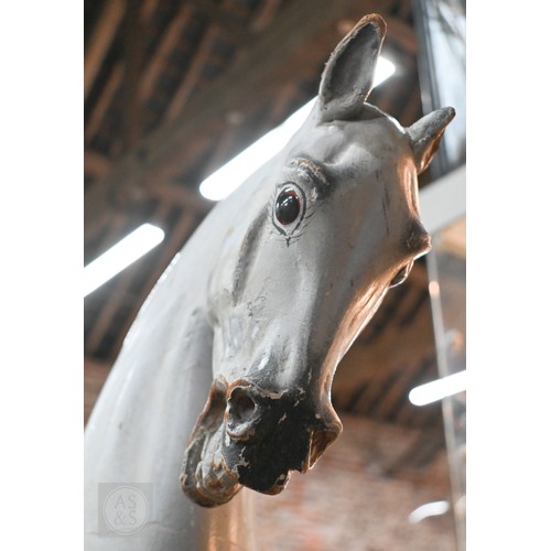 588 - An antique dapple grey painted wooden rocking horse with leather saddle, probably by FH Ayres, raise... 