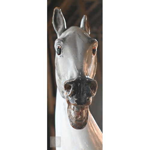 588 - An antique dapple grey painted wooden rocking horse with leather saddle, probably by FH Ayres, raise... 