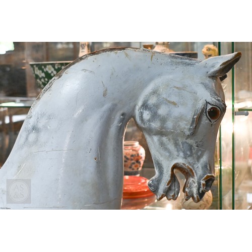588 - An antique dapple grey painted wooden rocking horse with leather saddle, probably by FH Ayres, raise... 