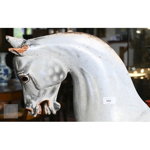 588 - An antique dapple grey painted wooden rocking horse with leather saddle, probably by FH Ayres, raise... 