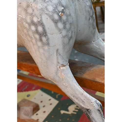 588 - An antique dapple grey painted wooden rocking horse with leather saddle, probably by FH Ayres, raise... 