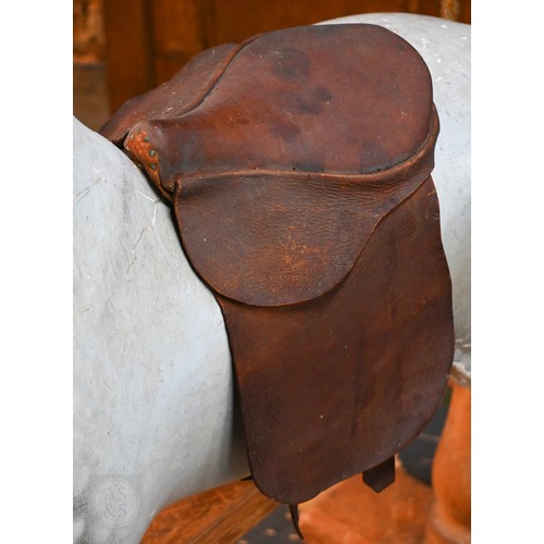 588 - An antique dapple grey painted wooden rocking horse with leather saddle, probably by FH Ayres, raise... 