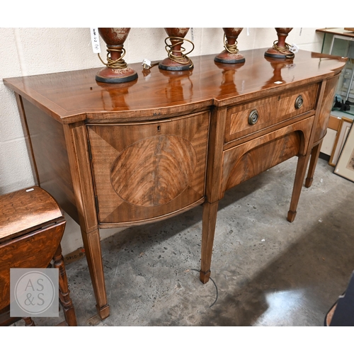 208 - An antique mahogany bowfront sideboard, two central drawers flanked by curved cupboard doors on tape... 