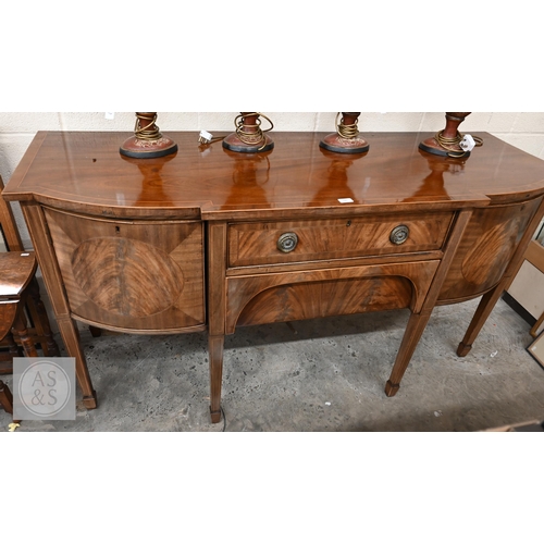 208 - An antique mahogany bowfront sideboard, two central drawers flanked by curved cupboard doors on tape... 