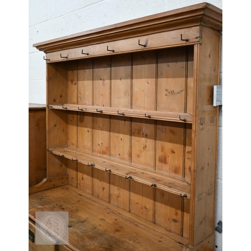 207 - A Victorian pine cottage dresser with two shelf plate rack over two drawers and panelled cupboards a... 