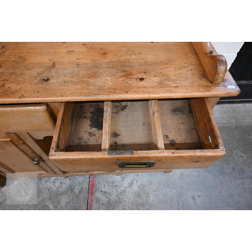 207 - A Victorian pine cottage dresser with two shelf plate rack over two drawers and panelled cupboards a... 