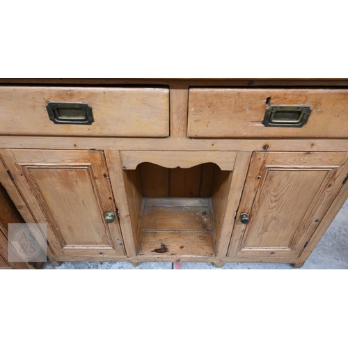 207 - A Victorian pine cottage dresser with two shelf plate rack over two drawers and panelled cupboards a... 