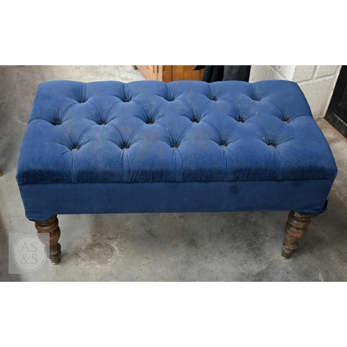 A blue velour button-upholstered footstool with four turned oak legs ...