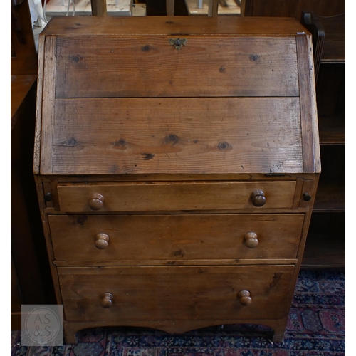 A rustic waxed pine fall front bureau with fitted interior over three ...