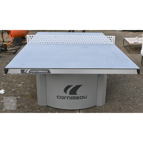 6 - A weathered 'Cornilleau' all-weather table tennis table, c/w four bats